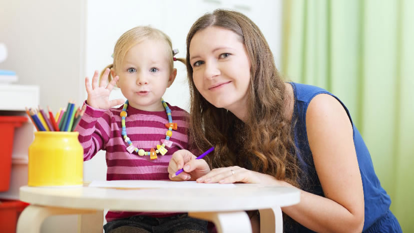 Young teacher and student drawing together